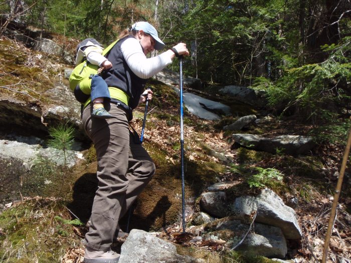 Lindsay and a sleeping Alden hike up the trail.