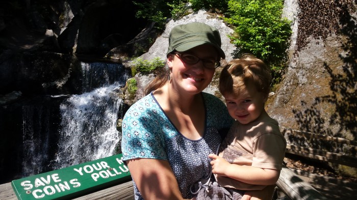 Lindsay and Alden pose in front of a large waterfall.