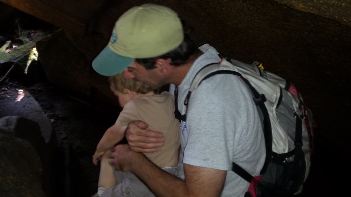 Andrew helps Alden through one of the caves.